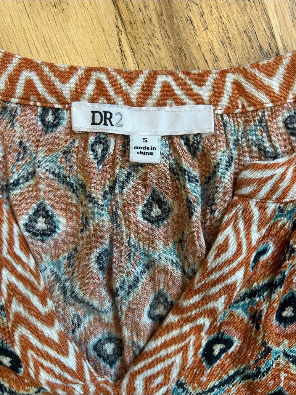 🌸3 FOR $20🌸
DR2 Rust and Teal Geometric V-Neck Cap Sleeve Blouse - Picture 3 of 7
